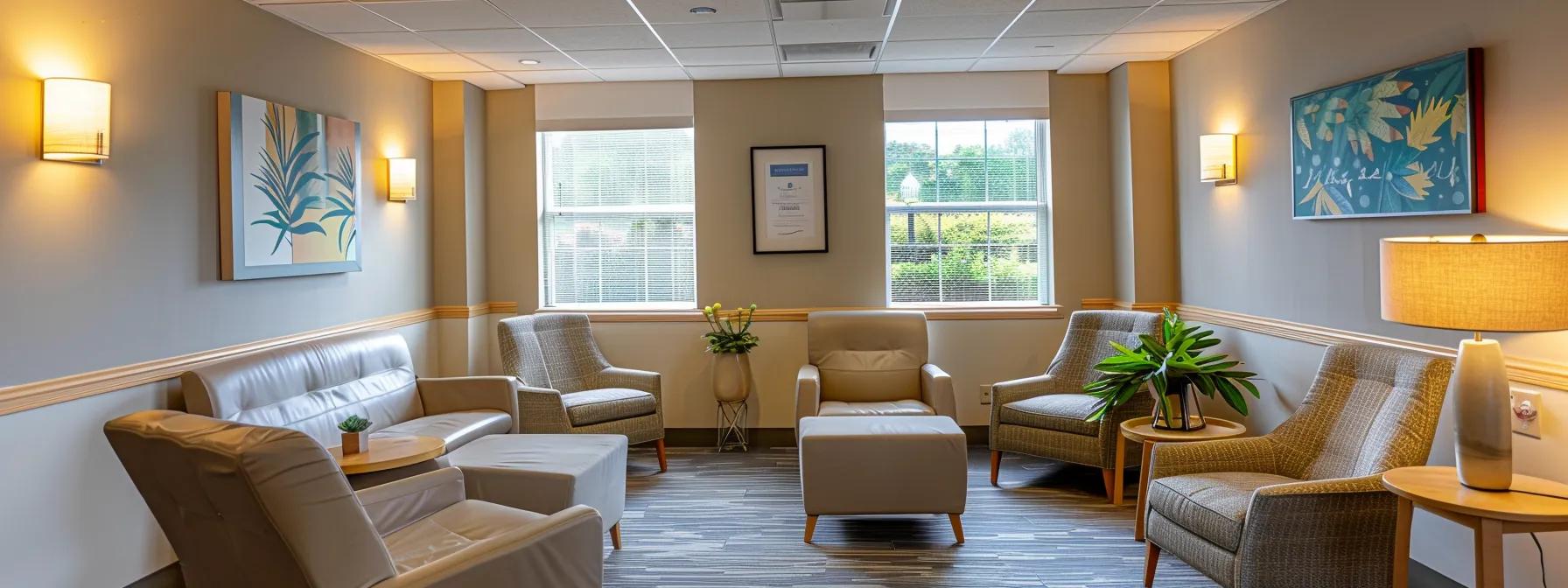 a room with chairs and a vase of flowers for addiction treatment in MA | Strenght Recovery Center | PHP IOP in MA