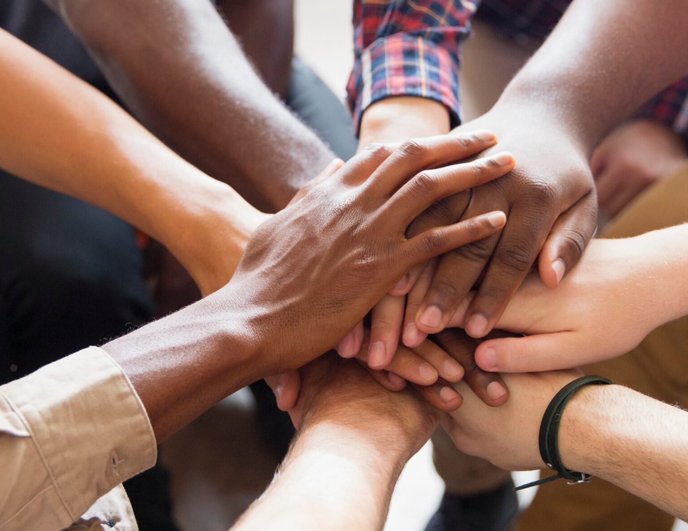 A group joining hands together in support